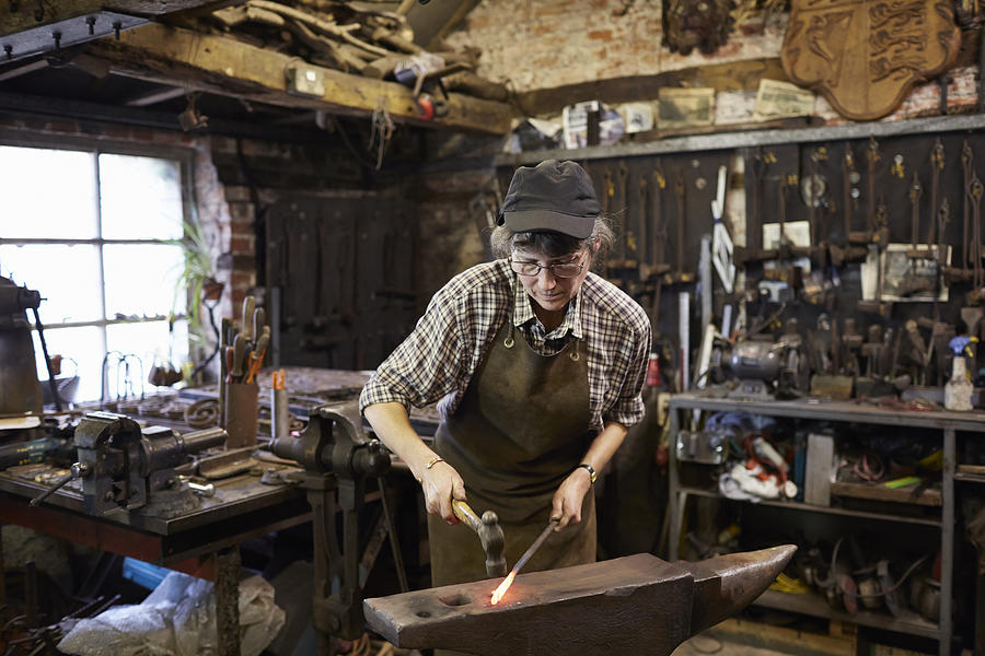Female blacksmith in her forge Photograph by Richard Drury