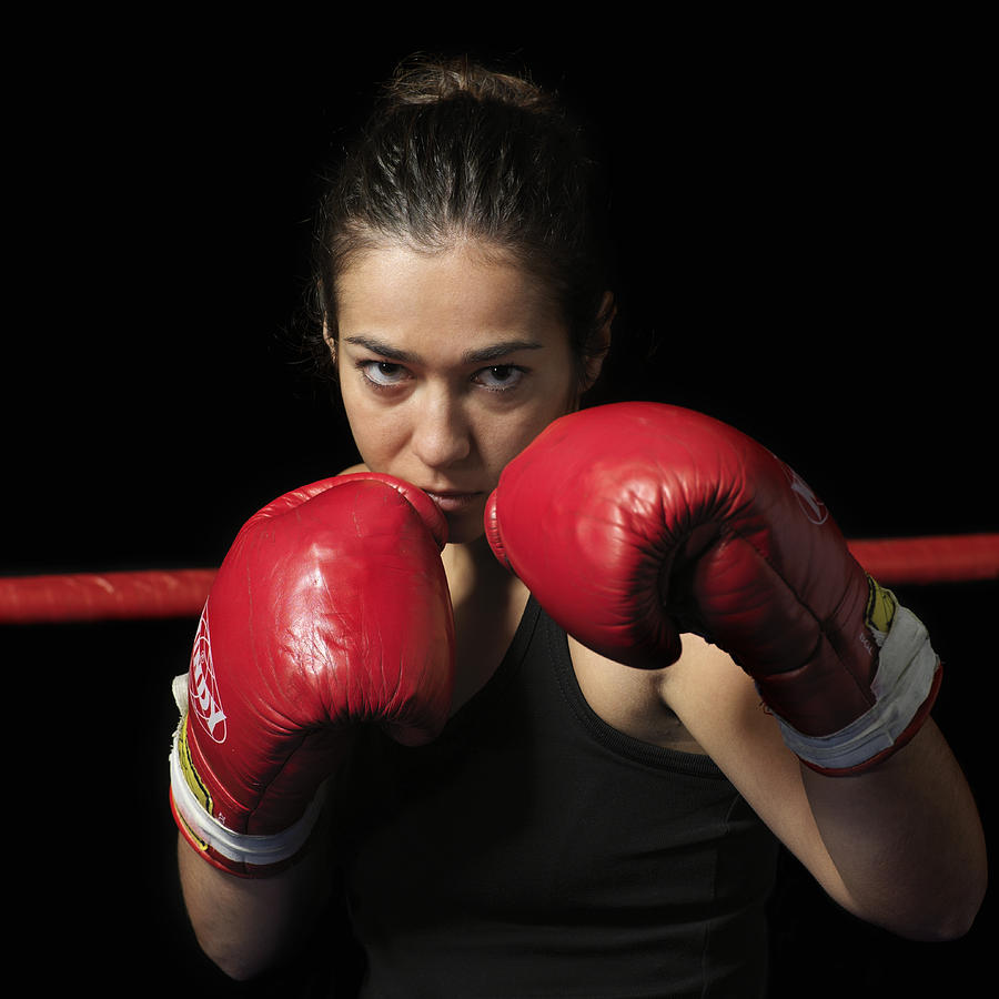 Female boxer with gloves up, portrait Photograph by Jonny Basker