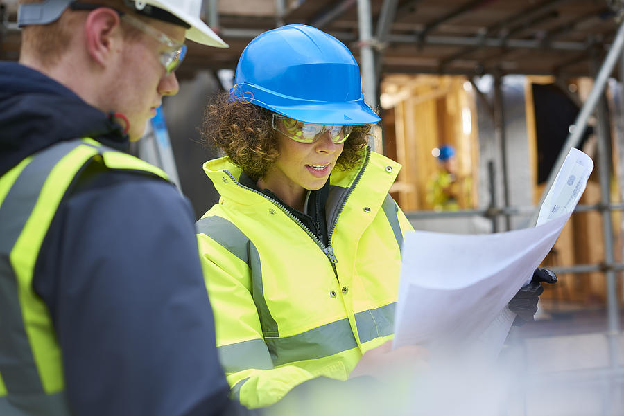 Female Construction Foreman Instructing A Worker . Photograph by Sturti