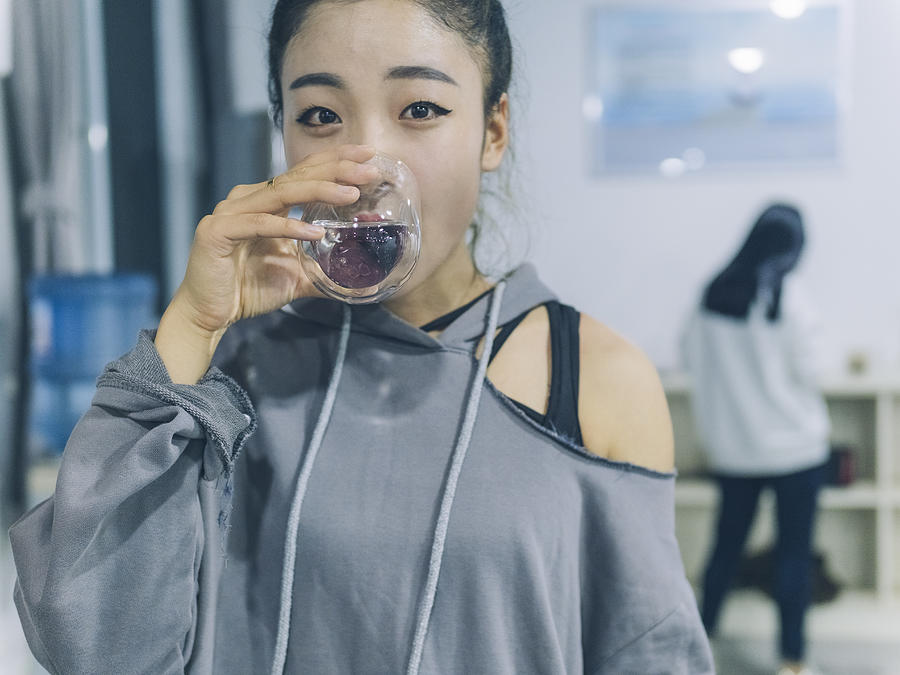 Female Dancer Drinking A Glass Of Water After Dancing In Studio Photograph by Aaaaimages