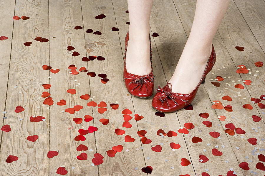 Female feet and heart shaped confetti Photograph by Image Source