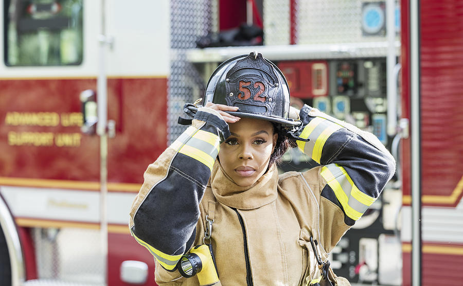 Female firefighter in fire protection suit Photograph by Kali9