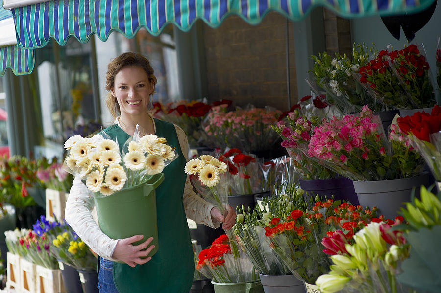 Female Florist Holding a Selection of Flowers Photograph by Mike Harrington