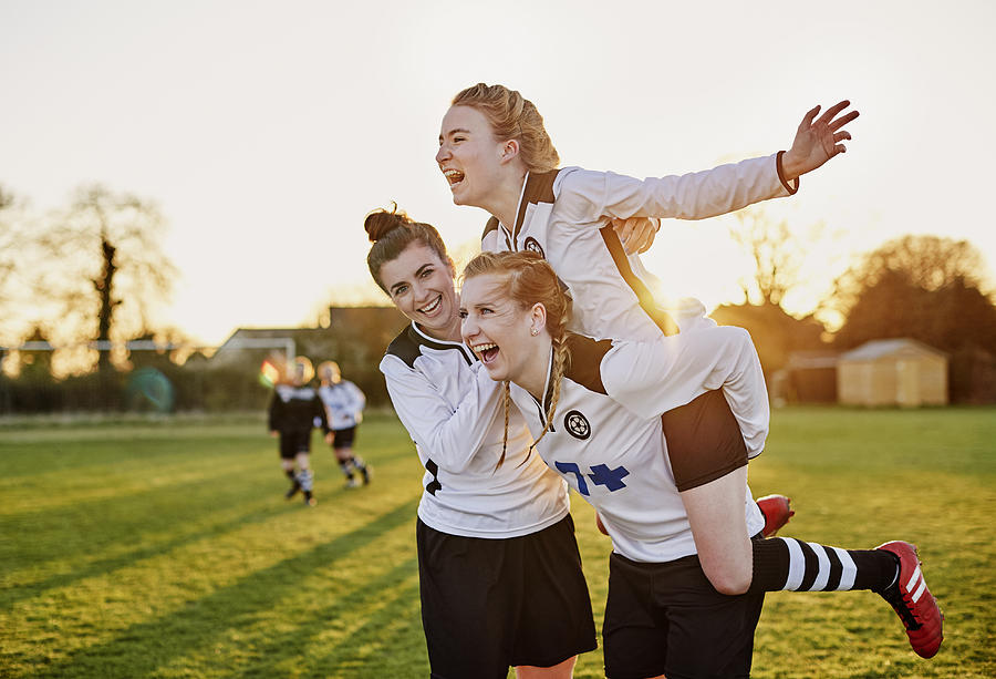 Female footballers celebrating goal Photograph by Mike Harrington