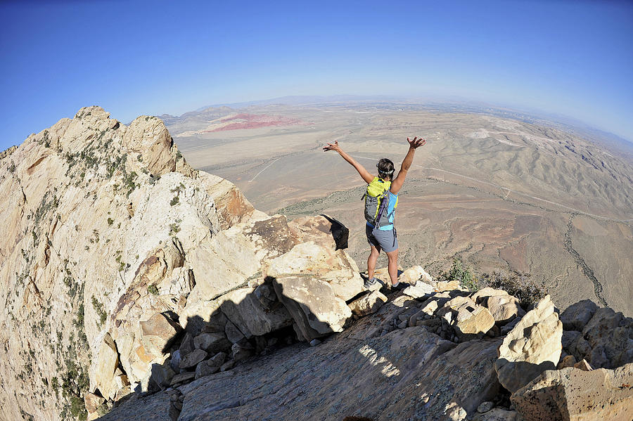 Female hiker celebrating on ridge, Mount Wilson, Red Rock Canyon, Nevada, USA Photograph by Hagephoto