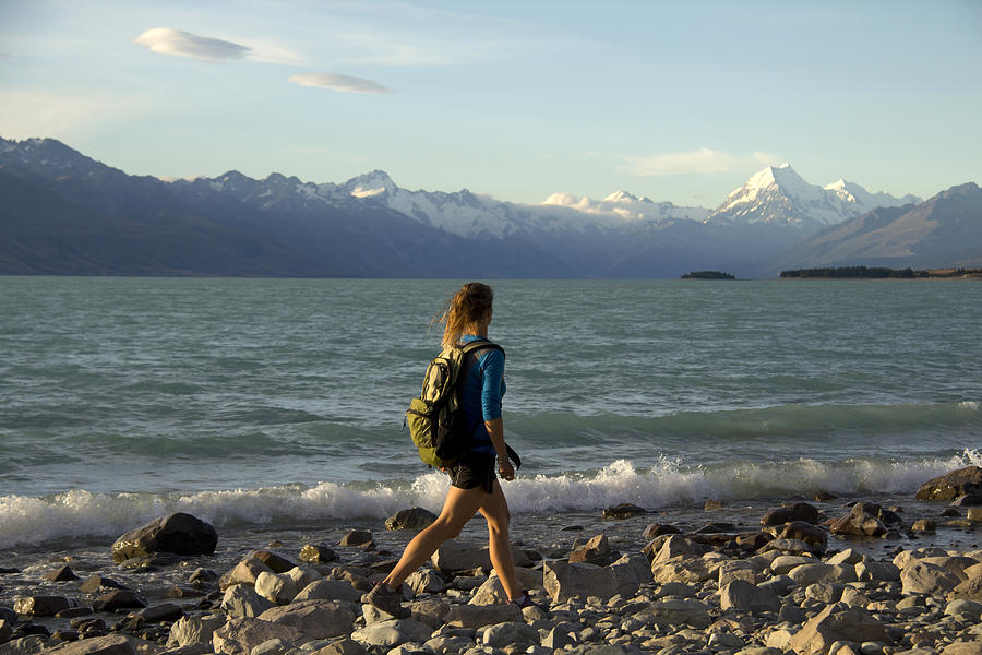 Female hiker on shores of Lake Pukaki Photograph by David Epperson