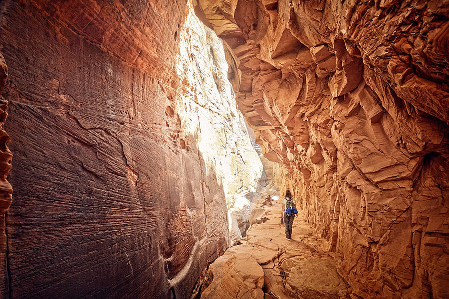 Female Hiker Walking Through Red Cave Photograph by James ONeil