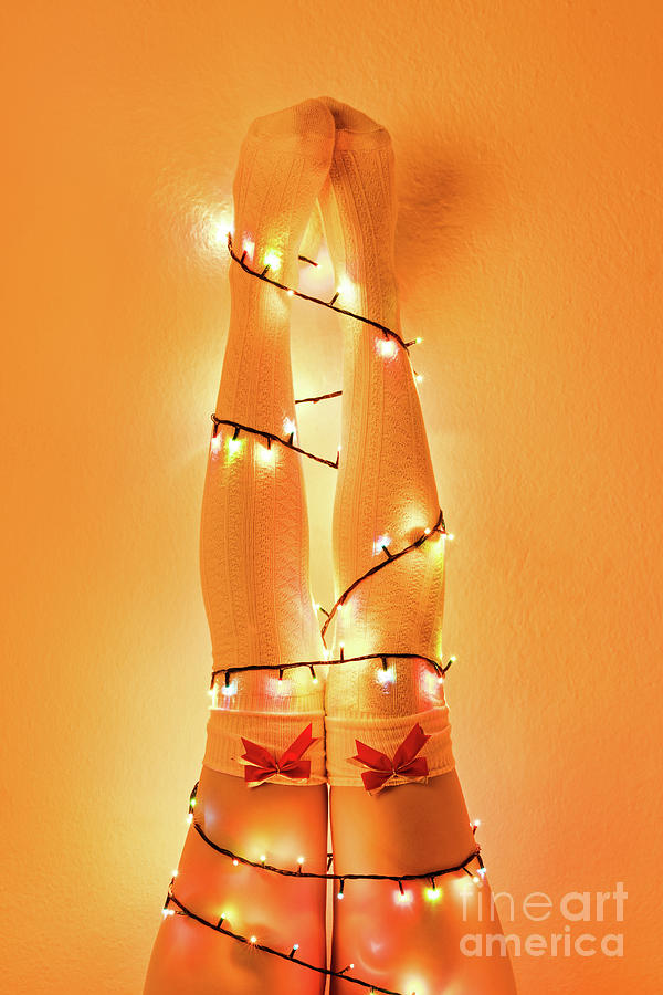 Female legs wrapped with christmas tree lights Photograph by Mendelex Photography
