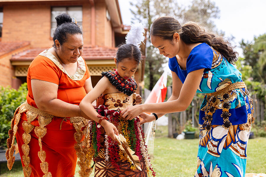 Female members of the Pacific Islander family preparing for the traditional dance performance in the back yard of their house Photograph by SrdjanPav Female members of the Pacific Islander family preparing for the traditional dance performance in the back yard of their house Photograph by SrdjanPav
