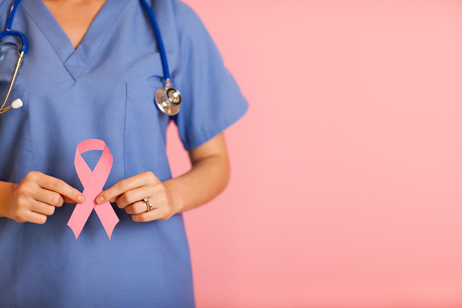 Female Nurse Holding Pink Breast Cancer Awareness Ribbon Photograph by Ideabug