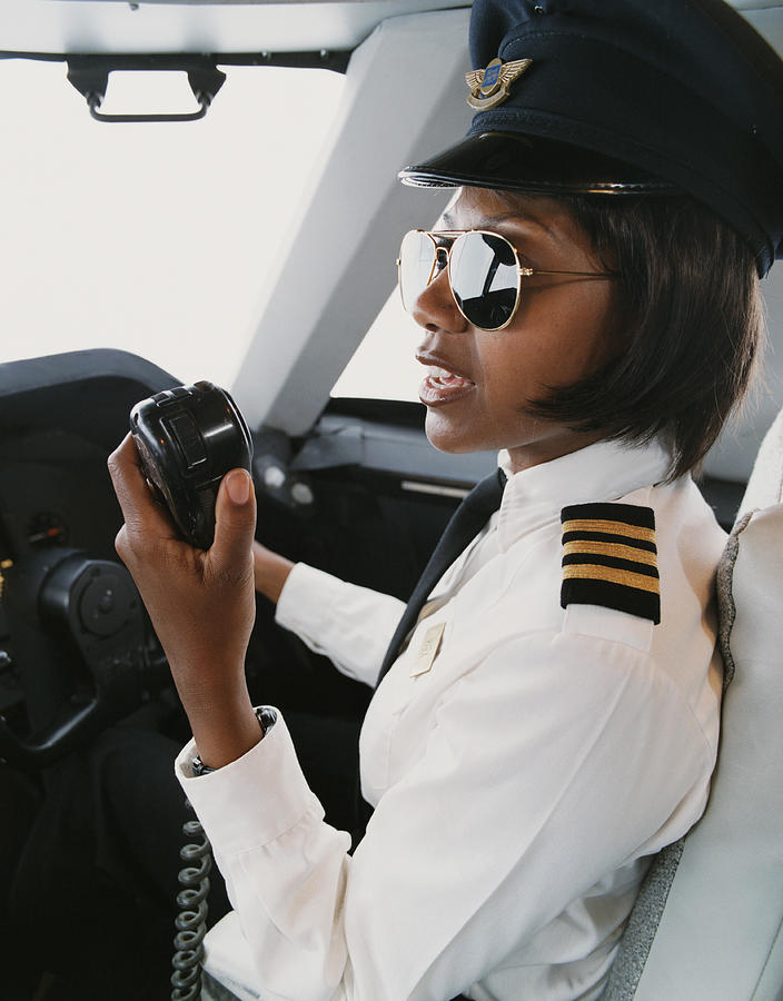 Female Pilot Talking into a Radio Photograph by Digital Vision.