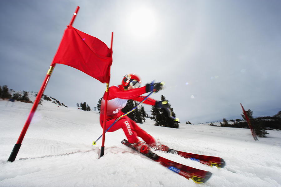 Female skier in giant slalom ski race (blurred motion) Photograph by Mike Powell