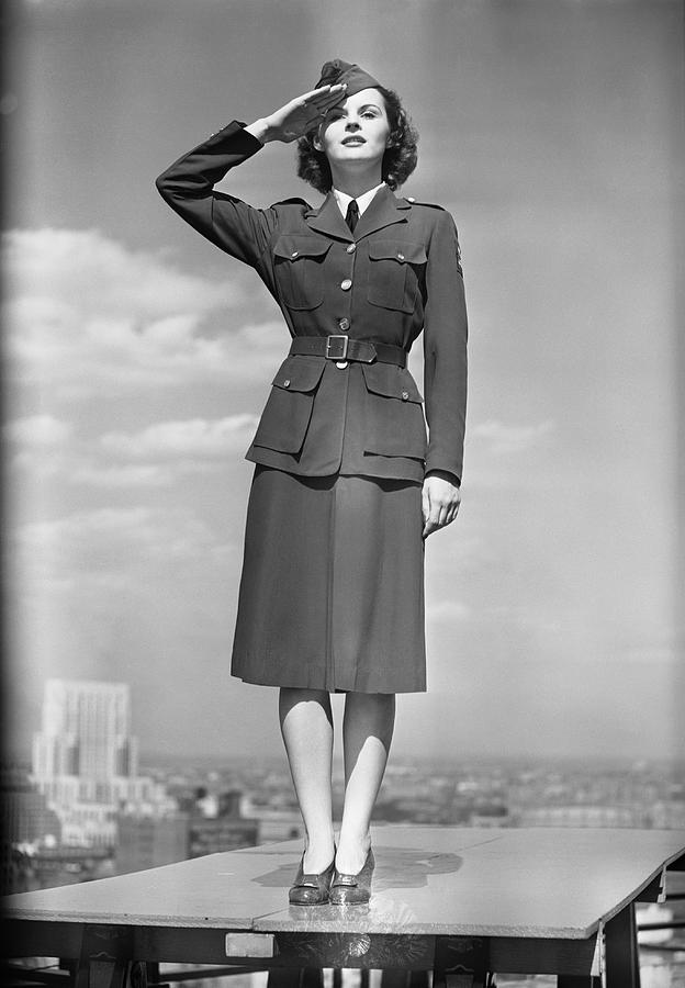 Female soldier standing on table and saluting Photograph by George Marks