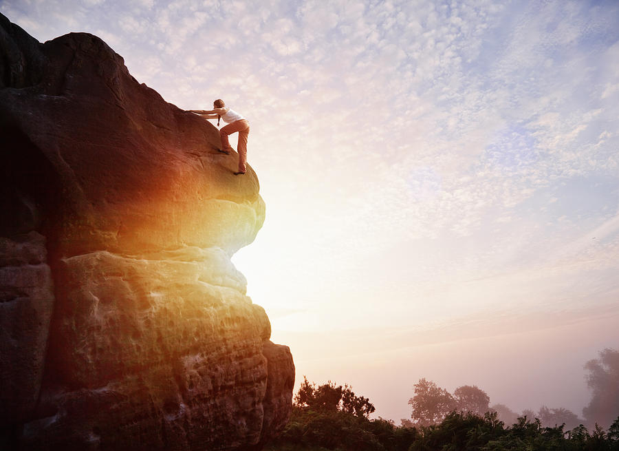Female solo climber nearing summit of rock Photograph by Robert Decelis Ltd