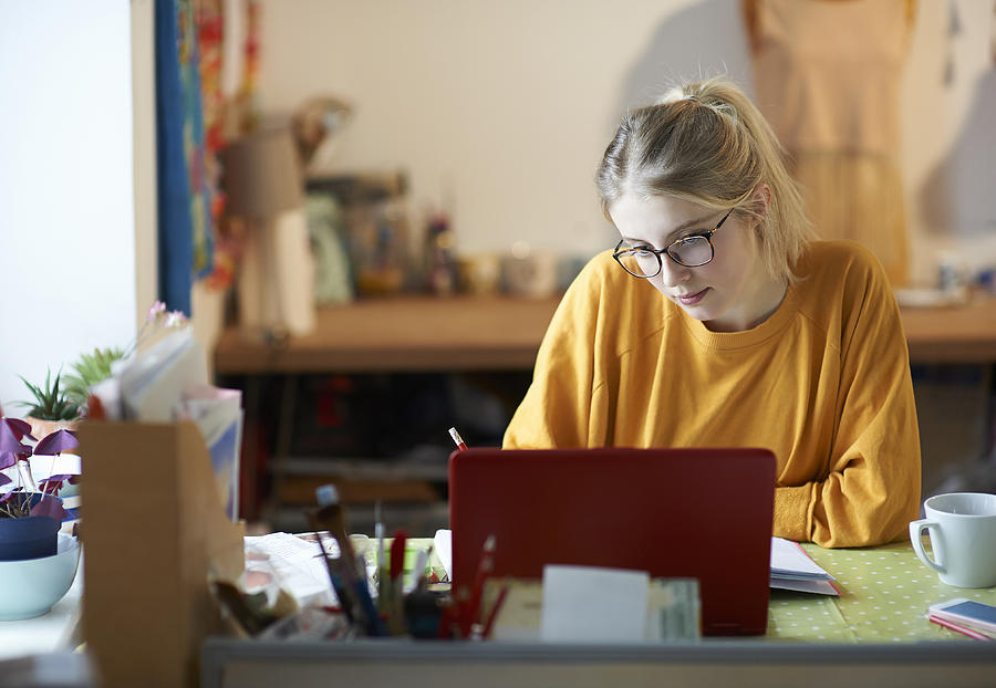 Female student at home studying. Photograph by Dougal Waters