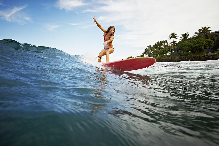 Female surfer riding wave view from water Photograph by Thomas Barwick