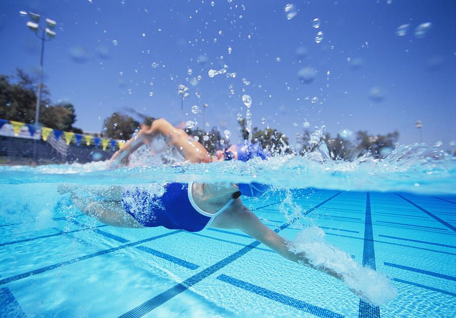Female swimmer in United States swimsuit swimming in pool Photograph by Moodboard