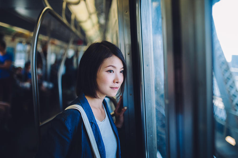 Female tourist on subway Photograph by Oscar Wong