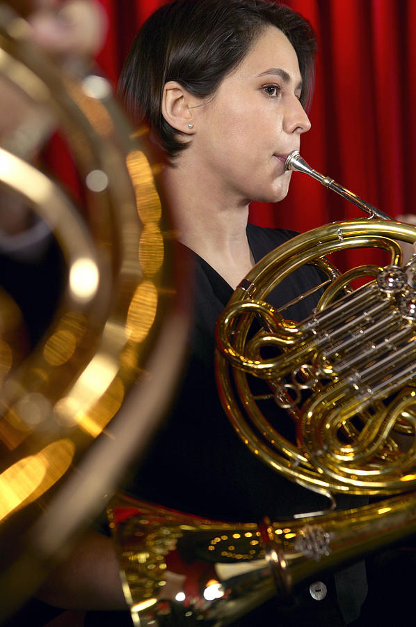 Female Trombonist Performing in an Orchestra Photograph by Digital Vision.