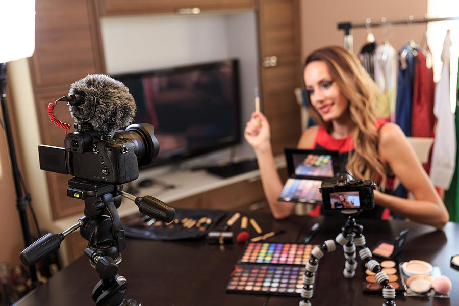Female vlogger filming make-up video Photograph by Valentinrussanov