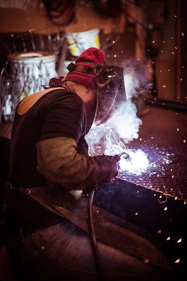 Female welder working in a workshop. Metal industry worker Photograph by MmeEmil