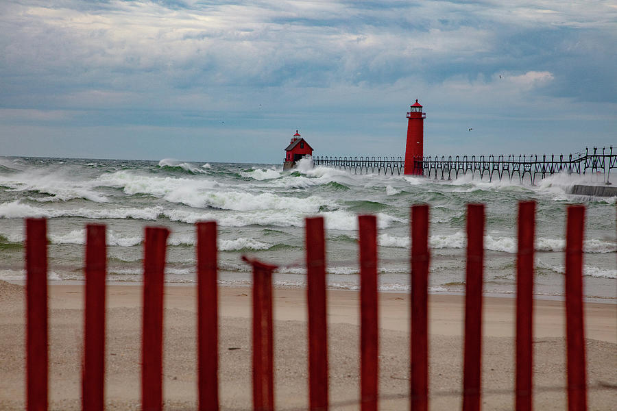 Fence and waves crashing at Grand Haven Pier in Michigan Photograph by Eldon McGraw