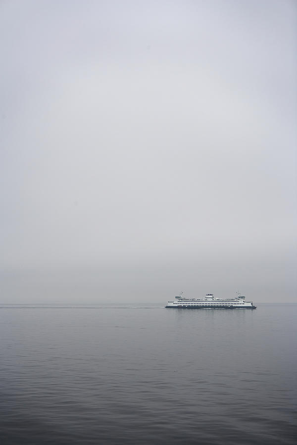 Ferry on sea, distant view Photograph by Thomas Northcut