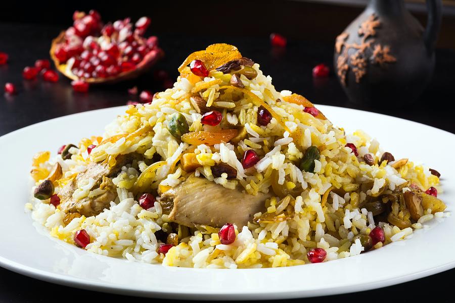 Festive middle eastern rice dish with chicken, orange peel and pistachios Photograph by Vladislavnosick