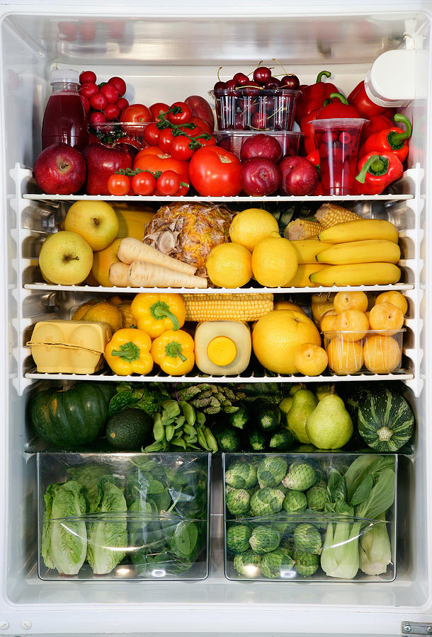 Fidge filled up with vegetables and fruit sorted by colour Photograph by Martin Poole