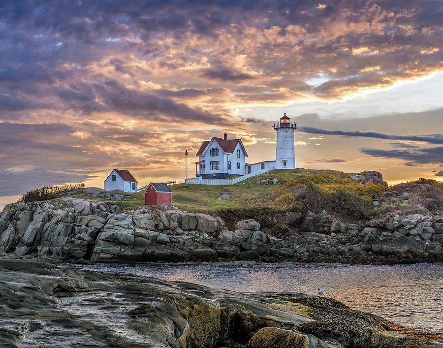 Fiery skies over Nubble Lighthouse Photograph by Robert Miller