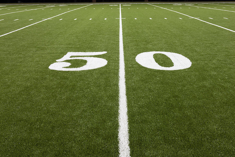 Fifty yard line on football field Photograph by PhotoAlto/Sandro Di Carlo Darsa
