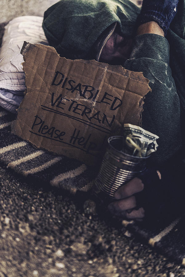 Fighting adversity. Homeless disabled veteran with sign and money tin Photograph by CatLane
