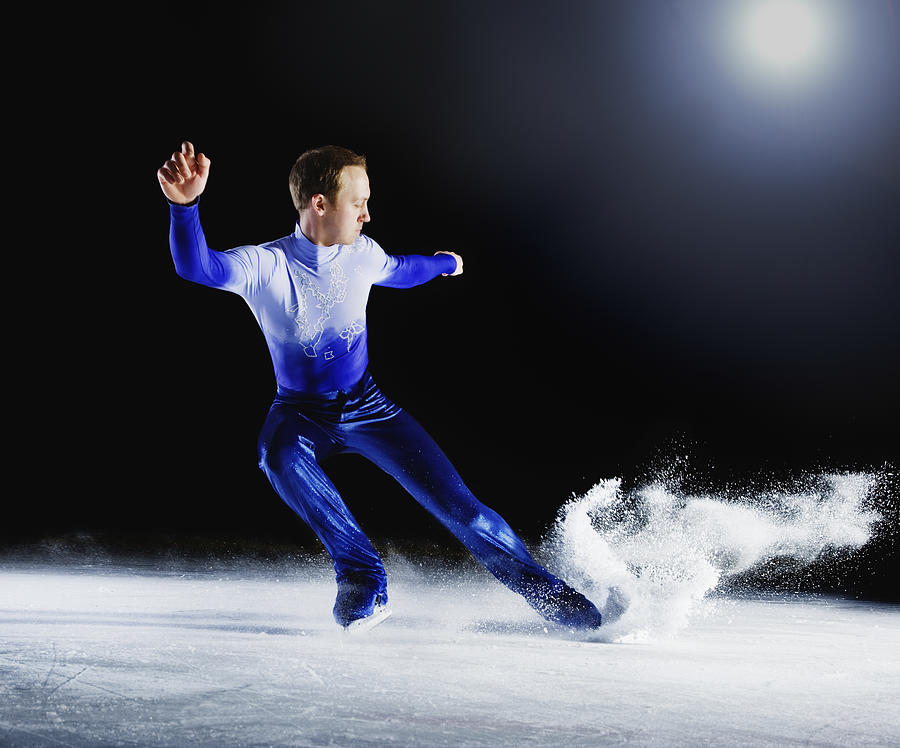 Figure skater creating spray of ice. Photograph by Robert Decelis Ltd