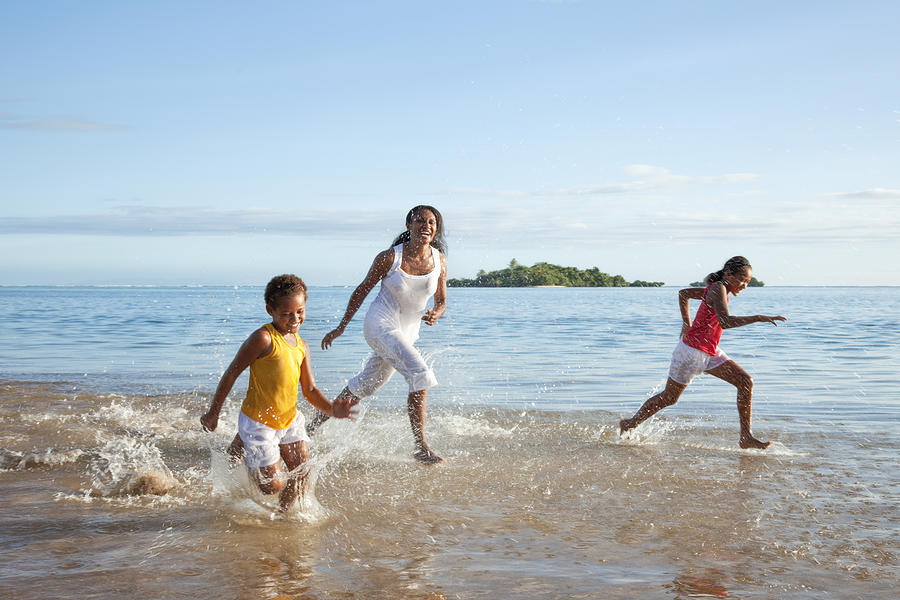 Fijian Mother and Daughters Running on Beach Photograph by Jhorrocks