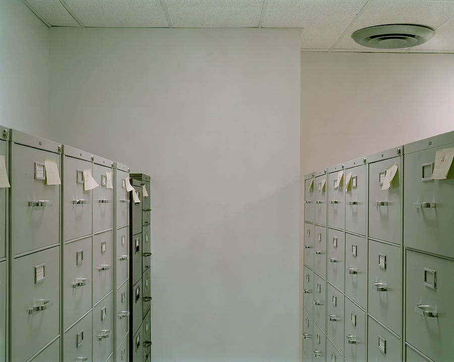 Filing cabinets with sticky notes in office Photograph by Erik Von Weber