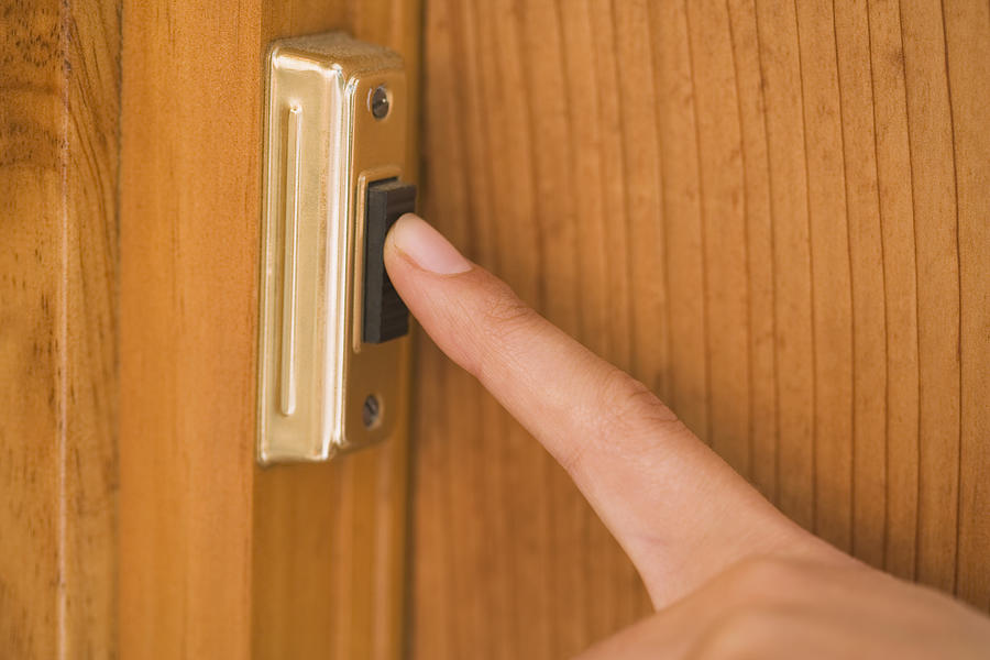 Finger pushing doorbell Photograph by Thinkstock Images