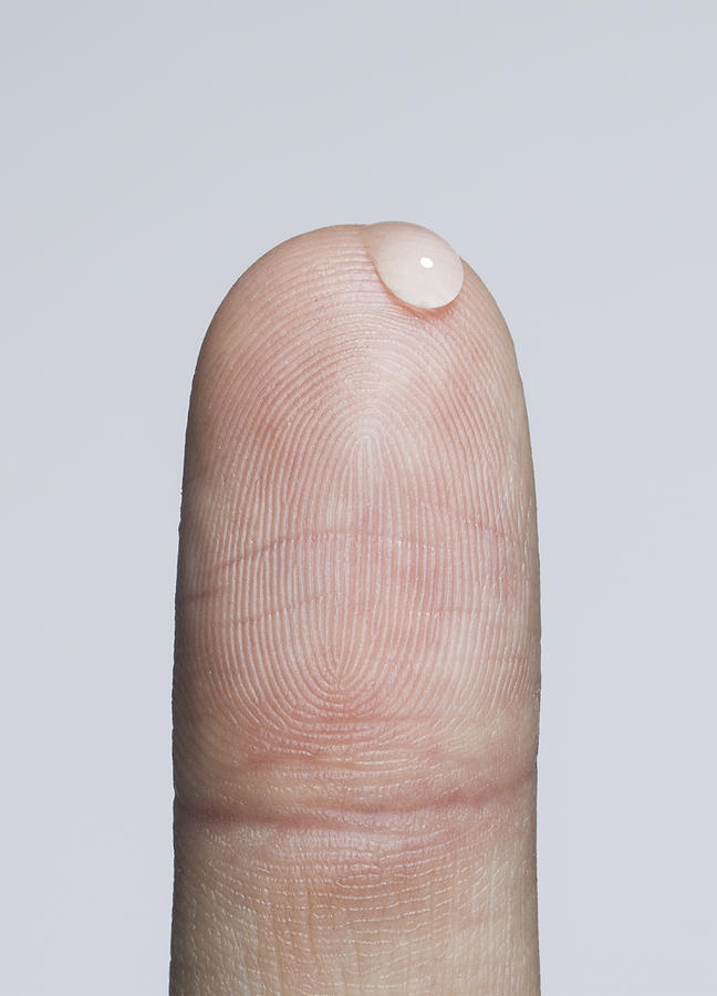 Finger with a bead of water Photograph by Jonathan Knowles