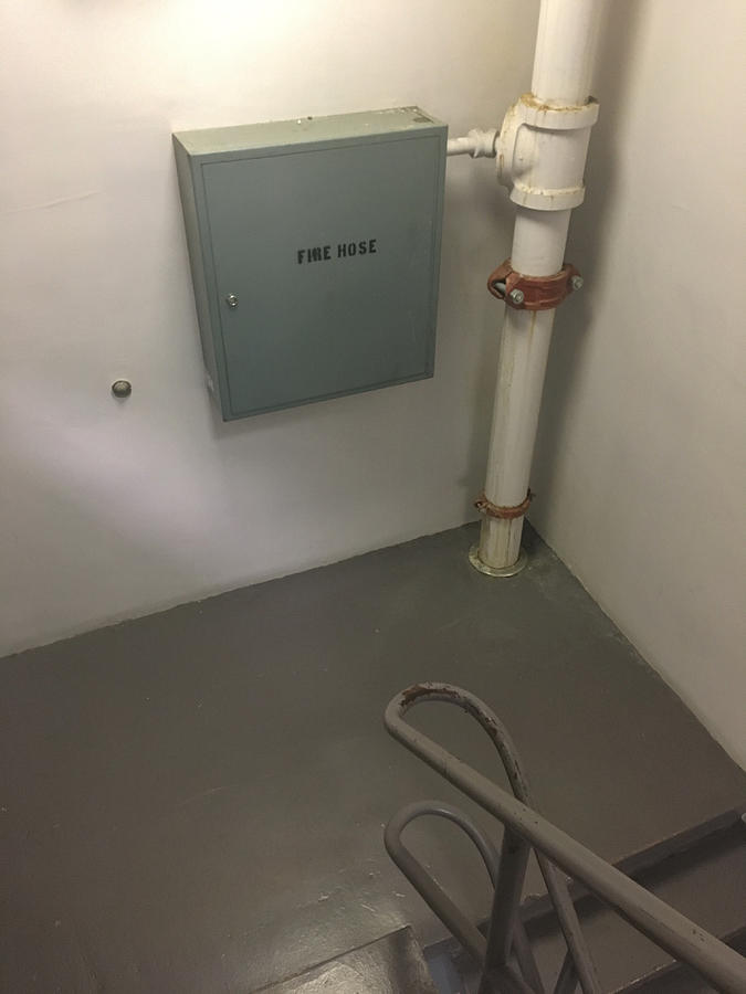 Fire hose box in a stairwell landing Photograph by Douglas Sacha