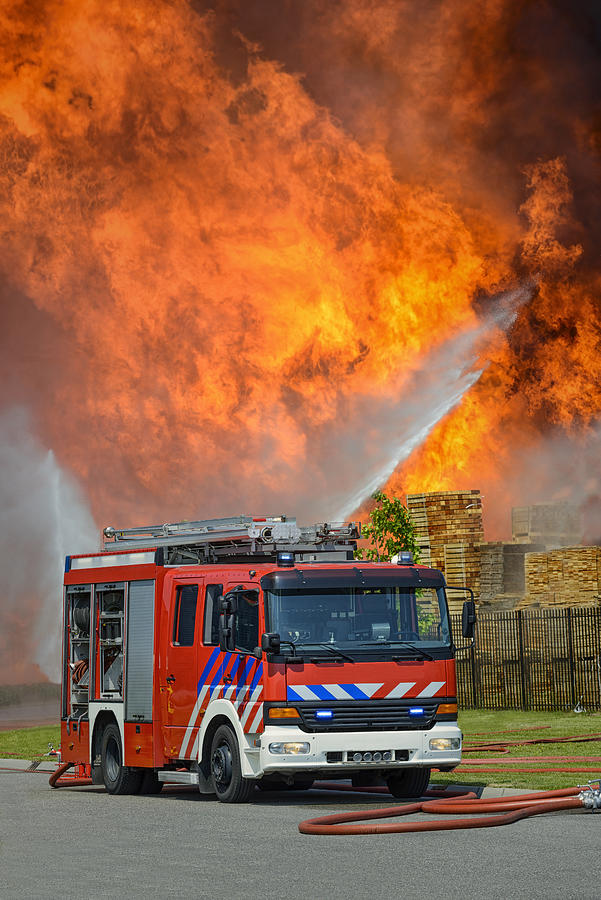 Fire Truck in front of huge flames Photograph by Sjo