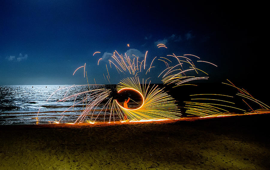 Fire twirling with sparks flying in the air Photograph by K.Muller