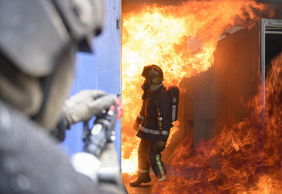 Firefighters in fire simulation training facility Photograph by Monty Rakusen