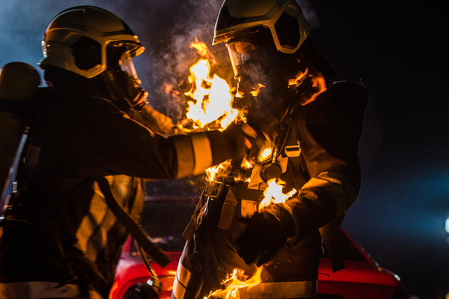 Firefighters with burning suit Photograph by Simonkr