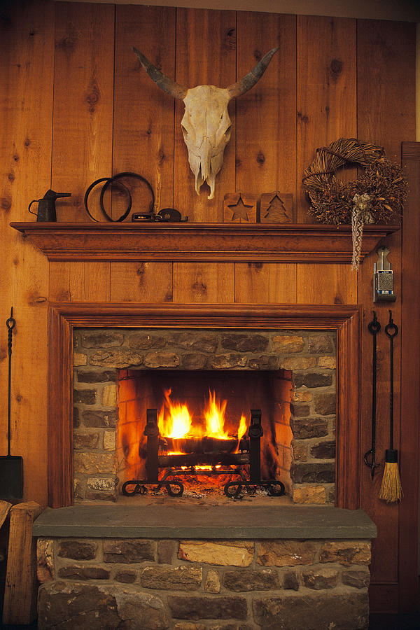 Fireplace and mantle in rustic western lodge Photograph by Comstock