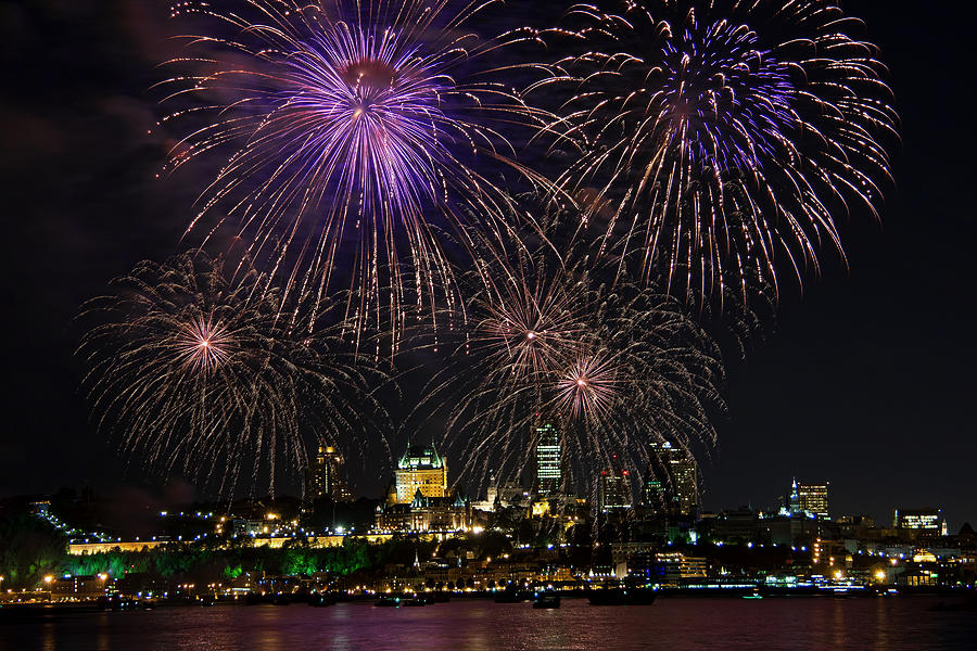 Fireworks display over city waterfront Photograph by Jean Surprenant