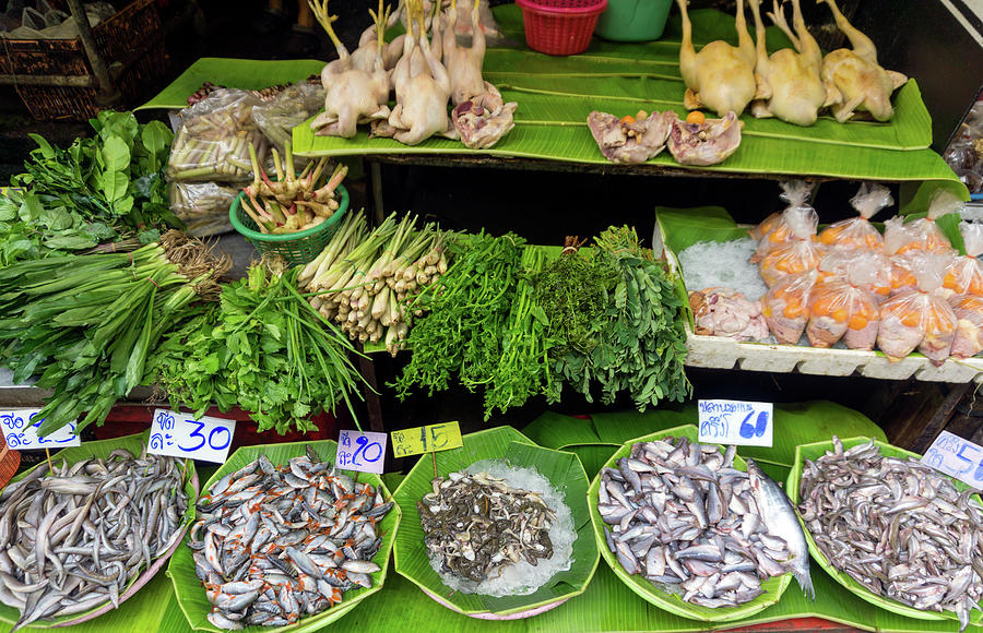 Fish, chicken and herbs on local market Photograph by Mikhail Kokhanchikov