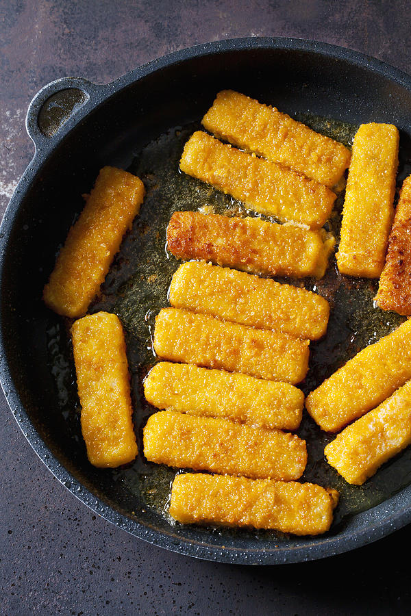 Fish fingers in frying pan Photograph by Westend61