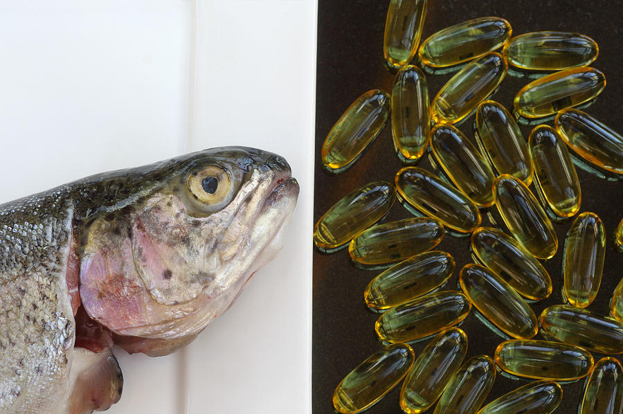 Fish oils from oily fish or capsules Photograph by Rosemary Calvert