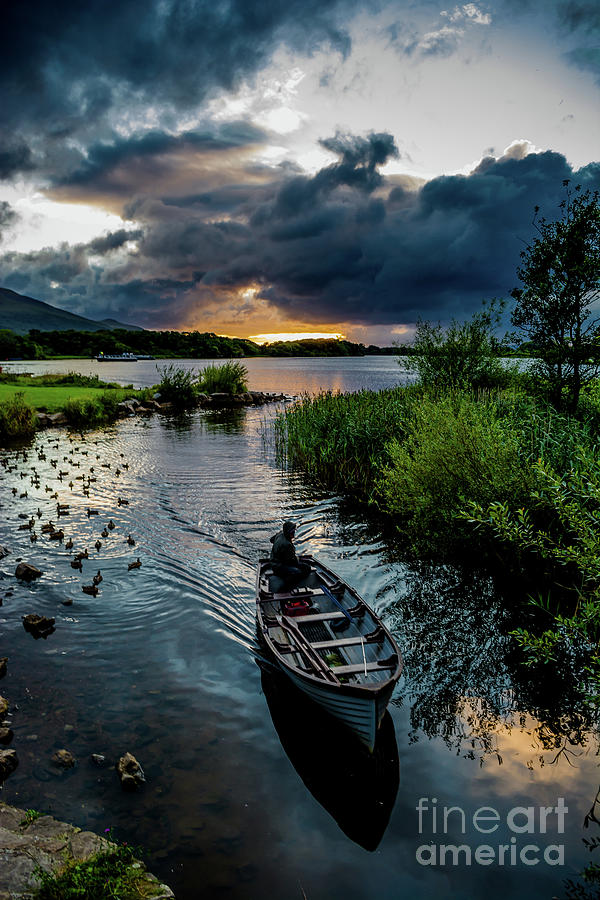 Fisher boat returns at sunset from Lough Leane in Killarney National Park  in Ireland Photograph by Andreas Berthold