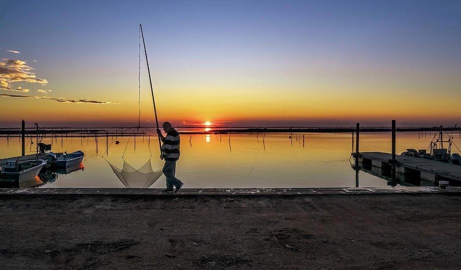 Fisherman at sunset. Photograph by Loredana Gallo Migliorini