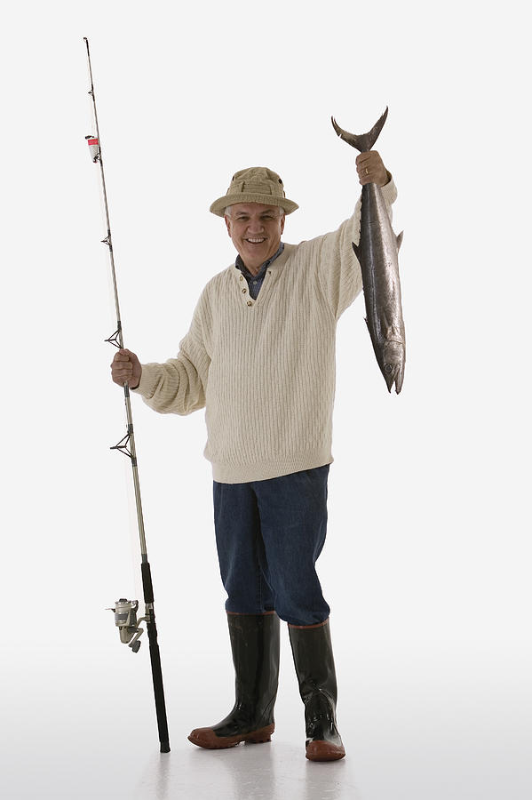 Fisherman with a fish Photograph by Comstock Images